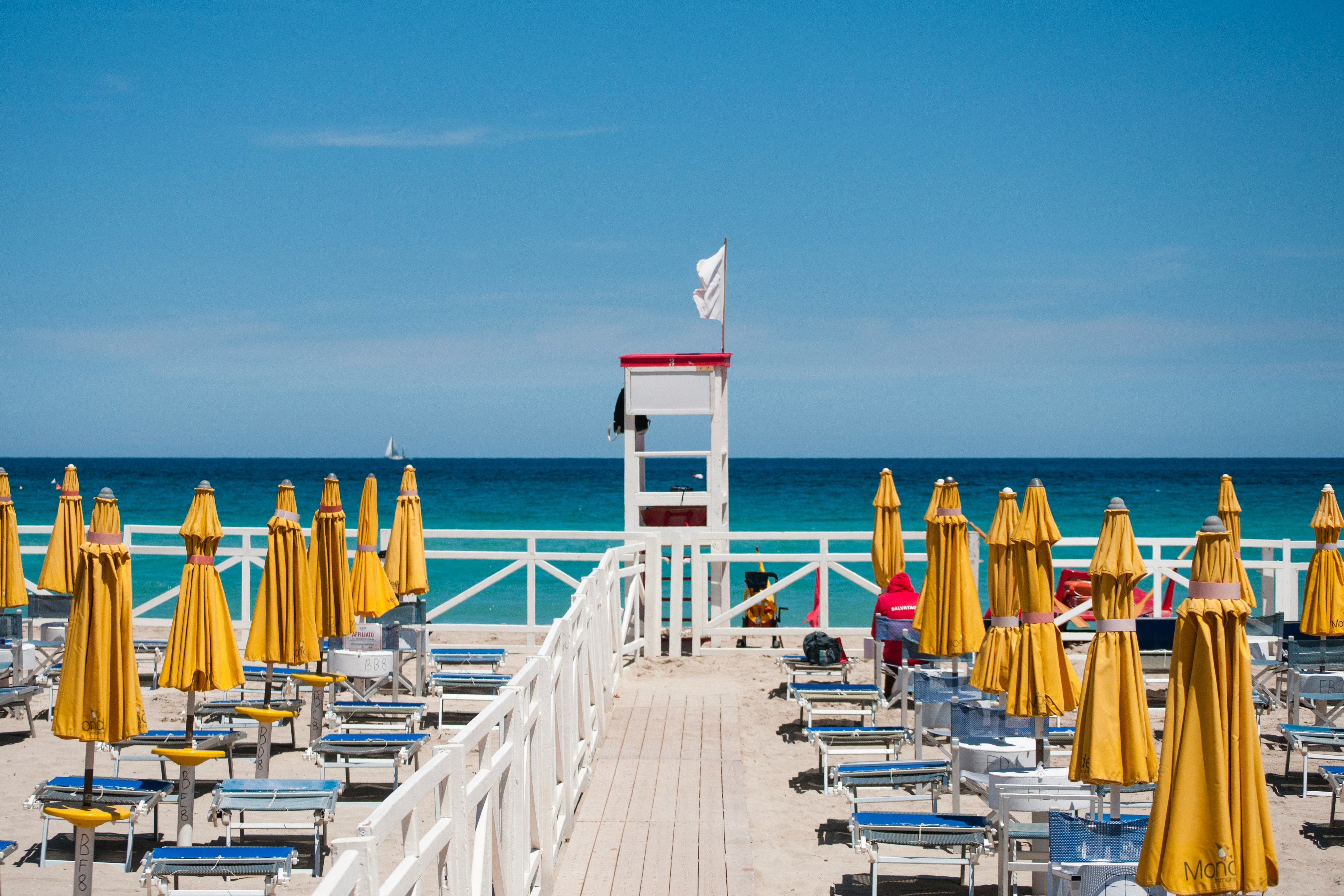 yellow beach umbrellas viewing blue sea during daytime